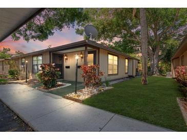 Charming condo featuring a well-maintained front yard and inviting landscaping at 1980 Tahitian Pl # 10, Dunedin, FL 34698