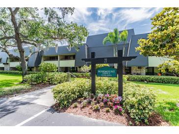 Rosemount Lodge condo building with landscaping at 36750 Us Highway 19 N # 21305, Palm Harbor, FL 34684