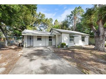 Cozy single-story house with a carport and a small front yard at 1320 Woodbine St, Clearwater, FL 33755
