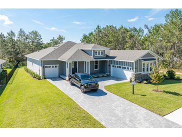 Two-story home with a three car garage and paver driveway at 6063 Dusk Rose Ln, Brooksville, FL 34601