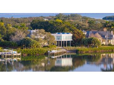 Breathtaking waterfront home featuring modern architecture, a private dock, and lush landscaping at 1761 Oceanview Dr, St Petersburg, FL 33715