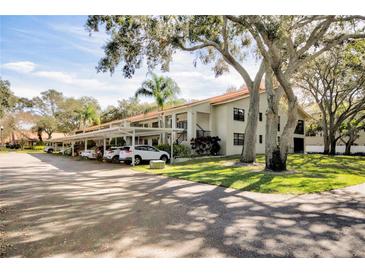 Exterior view of condo building with covered parking at 2020 Lakeview Dr # 203, Clearwater, FL 33763