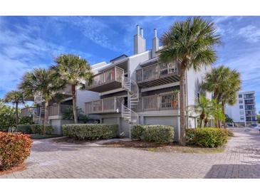 Two-story beach condo building with spiral staircases at 19930 Gulf Blvd # 1A, Indian Shores, FL 33785