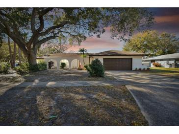 Charming single story home with mature landscaping and a two-car garage at 570 Casler Ave, Clearwater, FL 33755