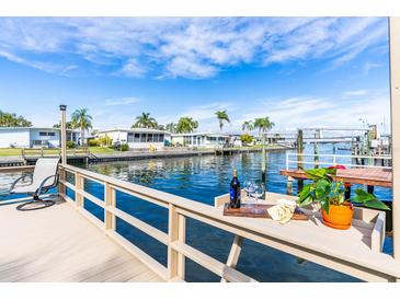 Relaxing waterfront dock with seating and a bottle of wine at 18675 Us Highway 19 N # 377, Clearwater, FL 33764