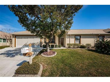 Charming single story home with a well-maintained lawn and screened garage at 4136 Rhone Dr, New Port Richey, FL 34655