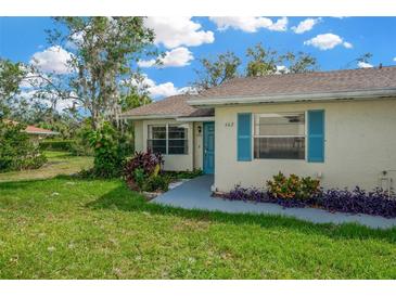 Cute Florida home with teal door and landscaped yard at 402 Lake Point Ct # D, Sun City Center, FL 33573