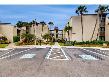 Exterior view of condo building with parking at 2205 Belleair Rd # A13, Clearwater, FL 33764