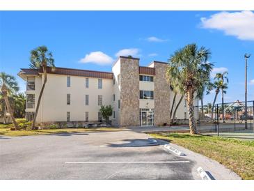 Condo building exterior with parking and tennis court at 4901 38Th S Way # 304, St Petersburg, FL 33711