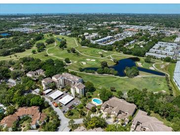 Beautiful aerial view of the community with golf course, lake, and tropical landscaping at 700 Starkey Rd # 333, Largo, FL 33771