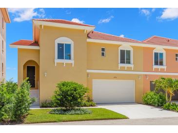 Two-story townhome with attached garage and landscaped front yard at 47A Bayview S Ct, St Petersburg, FL 33711