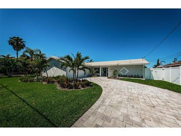 Beautiful home with a landscaped yard and paved driveway at 550 Johns Pass Ave, Madeira Beach, FL 33708