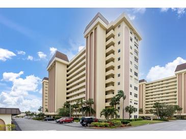 Condo building with parking and landscaping at 4550 Cove Cir # 1105, St Petersburg, FL 33708