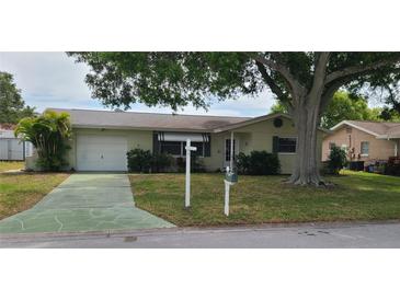 House exterior featuring a single-story home with a garage and landscaping at 9901 111Th Ln, Seminole, FL 33772