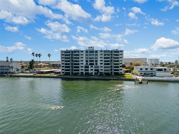 Aerial of waterfront condo building with swimming people at 300 Woodette Dr # 203, Dunedin, FL 34698