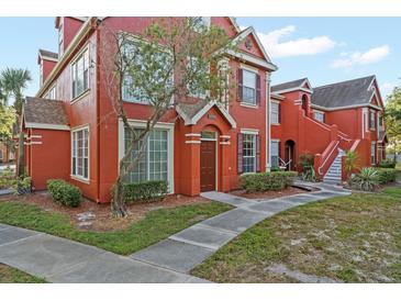 Two-story red building with landscaping and walkway at 10590 Windsor Lake Ct # 0, Tampa, FL 33626