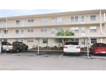 Two-story condo building with covered parking and landscaping at 948 Virginia St # 205, Dunedin, FL 34698
