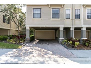 Townhouse exterior with covered parking and landscaping at 6226 Anhinga Pl, Tampa, FL 33615