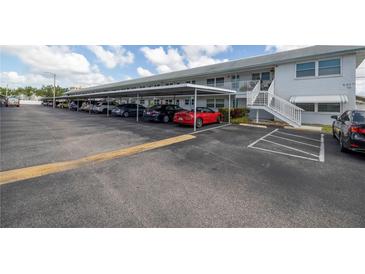 Covered parking area with cars parked in front of condo building at 5347 81St N Ln # 22, St Petersburg, FL 33709