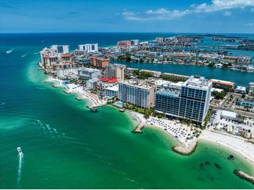 Breathtaking aerial view of beachfront property with turquoise waters at 675 S Gulfview Blvd # 903, Clearwater Beach, FL 33767