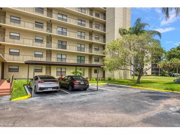 Covered parking with two cars parked under a carport at 900 Cove Cay Dr # 1H, Clearwater, FL 33760