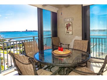 Condo balcony with glass-top table and chairs, offering water views at 1380 Gulf Blvd # 1008, Clearwater Beach, FL 33767