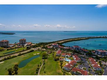 Aerial view of a waterfront community with a golf course, pool, and bridge at 6011 Bahia Del Mar Blvd # 150, St Petersburg, FL 33715