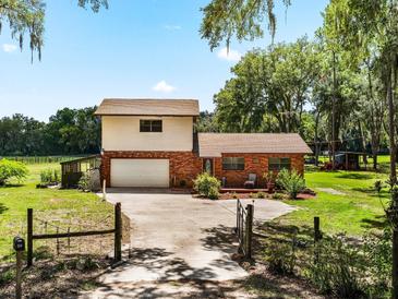 Two-story brick home with attached garage and spacious yard at 1811 Martin Rd, Dover, FL 33527