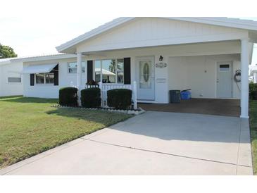 Bright white house with carport and small fence at 4251 100Th N Ave # 2, Pinellas Park, FL 33782