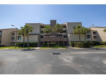 Condo building exterior with palm trees and parking at 2775 Kipps Colony S Dr # 204, St Petersburg, FL 33707