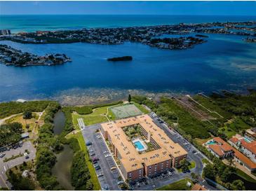 Aerial view of waterfront condo community with pool and tennis courts at 12760 Indian Rocks Rd # 1036, Largo, FL 33774