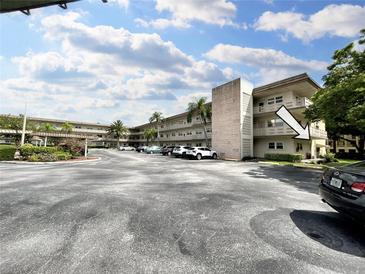 Two-story apartment building with ample parking and landscaping at 5750 80Th N St # C108, St Petersburg, FL 33709