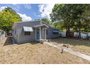 Gray house with a blue door, featuring a walkway and landscaping at 5609 20Th S Ave, Gulfport, FL 33707