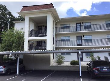 Two-story apartment building with covered parking and balconies at 1375 Doolittle Ln # 201, Dunedin, FL 34698