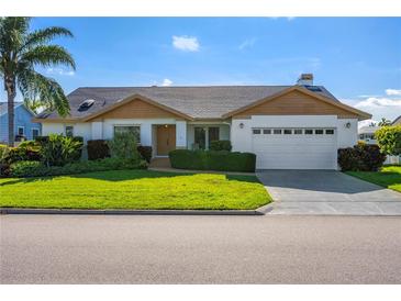 Charming single story home with a two-car garage and lush landscaping at 366 6Th N Ave, Tierra Verde, FL 33715