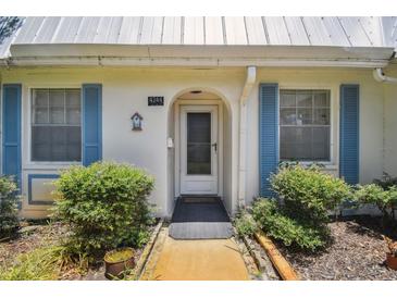 Quaint house exterior with blue shutters and walkway at 4244 Tamargo Dr, New Port Richey, FL 34652