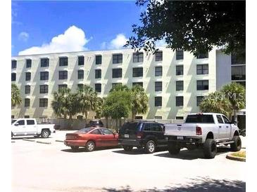 Building exterior with parking lot and several cars at 701 S Madison Ave # 106, Clearwater, FL 33756