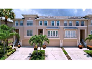 Three-story townhome building with attached garages at 7193 Islamorada Cir, Seminole, FL 33777