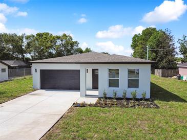 Newly built home with a well-maintained lawn and driveway at 7453 Blackhawk Trl, Spring Hill, FL 34606