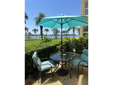 Relaxing patio with table and chairs, offering water views at 5130 Brittany S Dr # 106, St Petersburg, FL 33715