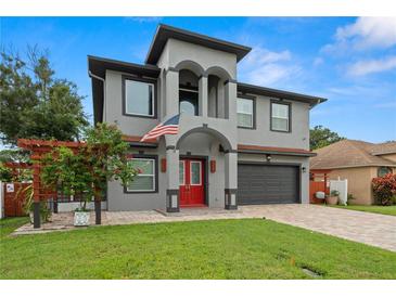 Stunning two-story home with a red door and landscaped yard at 6016 82Nd N Ter, Pinellas Park, FL 33781