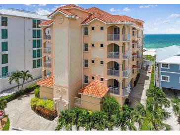 Oceanfront building, featuring terracotta tile roofs and balconies at 19820 Gulf Blvd # 401, Indian Shores, FL 33785