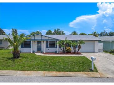 Charming ranch-style home with well-manicured lawn at 3543 Seffner Dr, Holiday, FL 34691