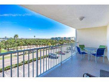 Enjoy water views from this condo's balcony, complete with a table and chairs at 19610 Gulf Blvd # 308, Indian Shores, FL 33785