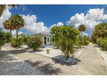 Cute bungalow style home with lush landscaping at 850 Mandalay Ave, Clearwater Beach, FL 33767