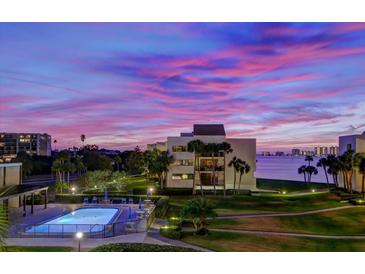 Evening view of community pool and waterfront at 50 Coe Rd # 311, Belleair, FL 33756