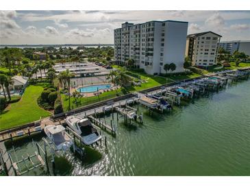 Waterfront condo complex featuring a marina, pool, tennis courts, and stunning views at 660 Island Way # 301, Clearwater Beach, FL 33767