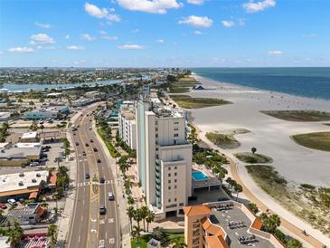 Expansive aerial view of the beachfront condo and pristine shoreline at 11000 Gulf Blvd # 301, Treasure Island, FL 33706