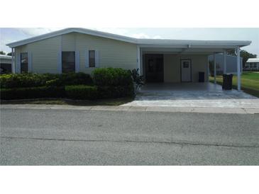 Mobile home with carport and well-maintained landscaping at 231 Tarpon Ln, Oldsmar, FL 34677