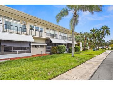 Exterior view of a two-story building with balconies at 4001 58Th N St # 16, Kenneth City, FL 33709
